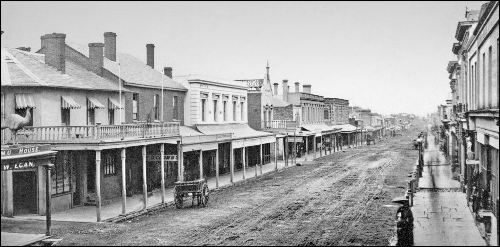 Hindley Street on a wet day circa 1870. Muddy boots and shoes on everyone. Mind the horse poo!