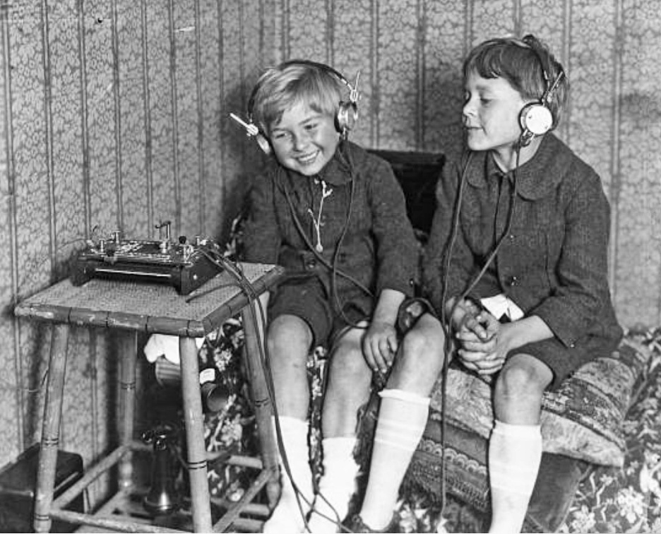 Some Boys listening to a Crystal Set circa 1920 – one hundred years later earphones made a comeback
